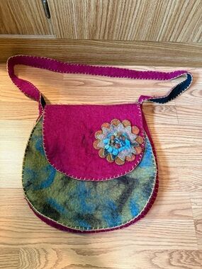 Rising Tide felted wool crossbody bag featuring a floral appliqué